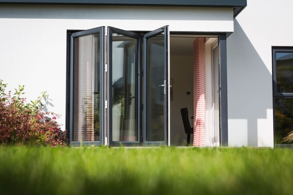 An anthracite grey bi-fold door on the rear of a contemporary home